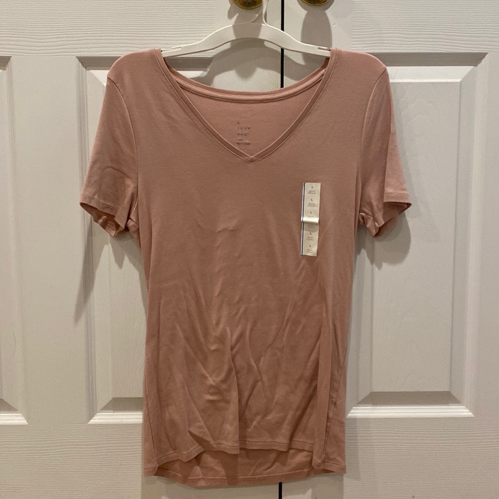 Light pink t-shirt. Brand new, never worn. Size L.
